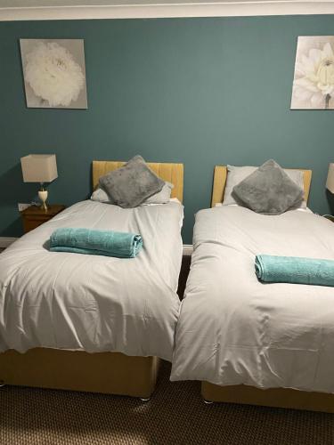two beds sitting next to each other in a room at The Granary Bar & Grill in Long Sutton