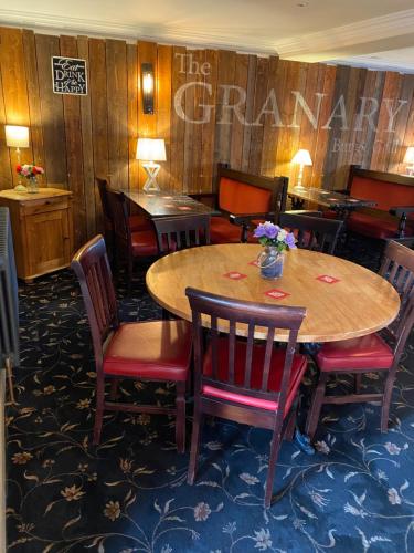 a dining room with a table and chairs at The Granary Bar & Grill in Long Sutton