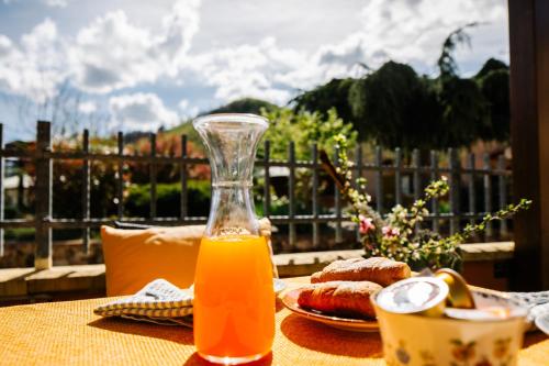 a glass jug of orange juice sitting on a table at Selvicolle Country House in Crispiero
