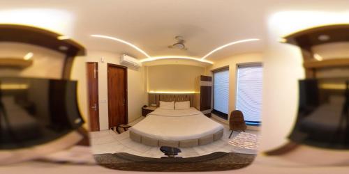 a bedroom with two beds and a flat screen tv at Hotel G-2 in Jalandhar