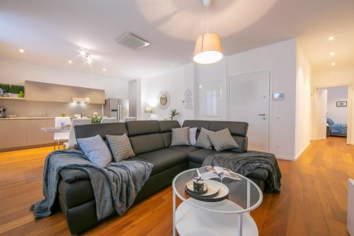 a living room with a couch and a kitchen at Star of Lugano in Lugano