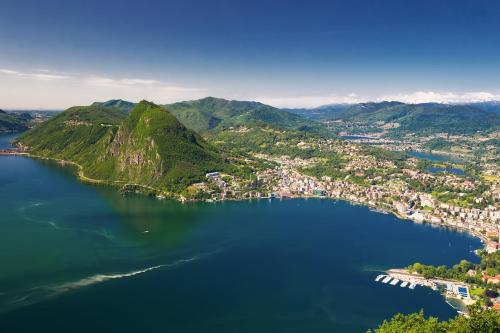 an aerial view of a large lake with mountains at Star of Lugano - Happy Rentals in Lugano