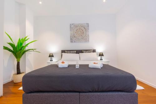 a bedroom with a large bed with two pillows at Love of Lugano - Happy Rentals in Lugano