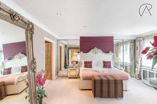 a bedroom with two beds and a mirror at Luxury Ascot Home With Indoor Heated Pool & Cinema in Ascot