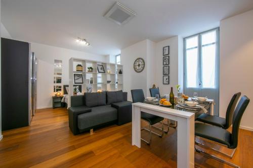 a living room with a table and a couch and a dining room at Little Lugano in Lugano