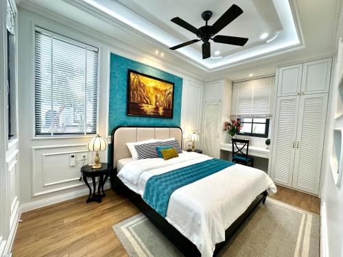 a bedroom with a bed and a ceiling fan at Ký ức Đông Dương in Quang Ninh