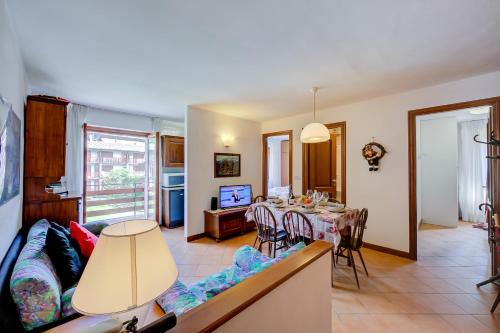a living room with a table and a couch at Bramé La Fam 32 few steps from skiing - Happy Rentals in Bardonecchia