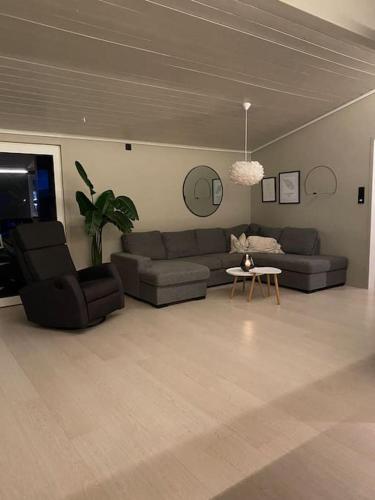 a living room with two couches and a table at Aurora panorama 2nd floor in Laksvatn