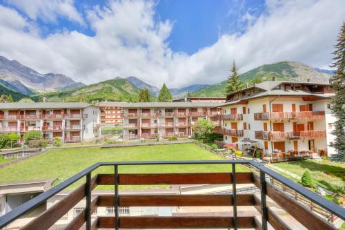 a view from the balcony of a resort with mountains at Bramé La Fam 32 few steps from skiing - Happy Rentals in Bardonecchia