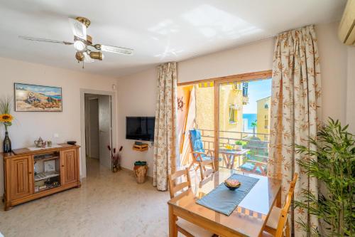 a living room with a table and a dining room at Rincón Playa, terraza y piscina in Rincón de la Victoria