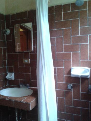 a bathroom with a sink and a mirror at Hotel Sautto in San Miguel de Allende