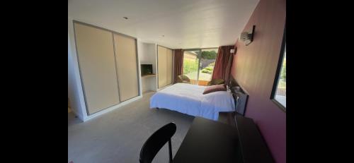 a small bedroom with a bed and a window at B&B - Villa des Remparts - Ardres proche Calais-St Omer-Dunkerque in Ardres