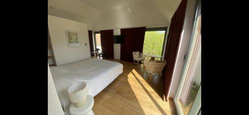 a small bedroom with a bed and a window at B&B - Villa des Remparts - Ardres proche Calais-St Omer-Dunkerque in Ardres