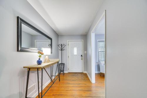a hallway with a table and a mirror on a wall at Raleigh Retreat about 5 Mi to Dtwn and Historic Oakwood! in Raleigh