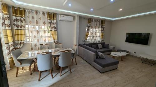 a living room with a table and a couch at Clarisse Lodge in Lomé
