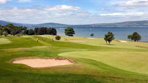 a golf course with a view of the water at The Nines in Bangor