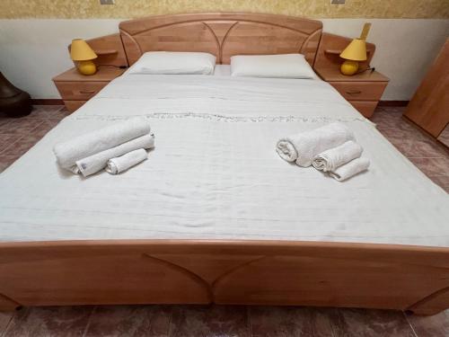 a bed with white sheets and towels on it at La Taverna Di Felice in Campomarino