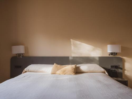 Un ou plusieurs lits dans un hébergement de l'établissement Tramas Hotel & Spa