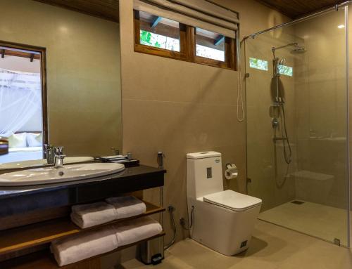 a bathroom with a sink and a toilet and a shower at Sigiriya Forest Edge By Marino Leisure in Sigiriya