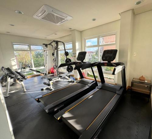 a gym with a treadmill and a elliptical machine at 2 Bedroom and 1 Bedroom Apartments with Private Pool and Gym in Puerto Princesa City