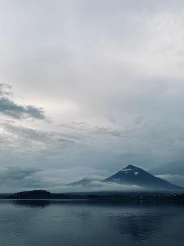 a mountain in the middle of a body of water at Ruhondo Beach Resort in Ruhengeri