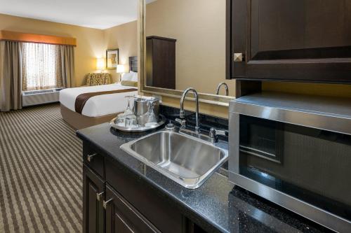 a bathroom with a sink in a hotel room at Best Western Sunrise Inn & Suites in Stony Plain
