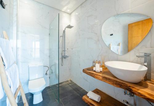 a bathroom with a sink and a glass shower at dar al walidine in Marrakesh