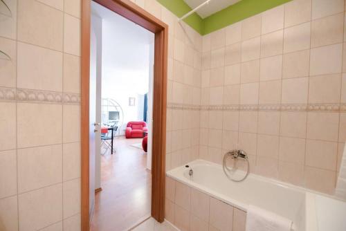 a bathroom with a bath tub in a room at Bright and homey AC apartment near the center in Budapest