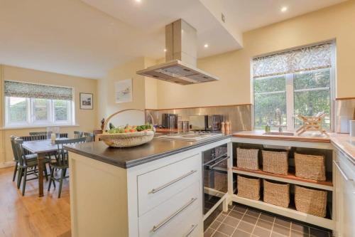 a kitchen with a counter with a bowl of fruit on it at Gardeners Cottage - Hot Tub Packages Available in Market Harborough