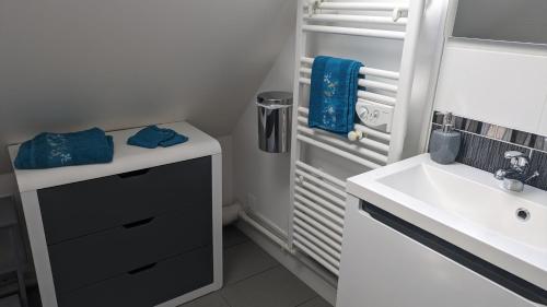 a small white bathroom with a sink and a sink at Chambre d'Hôtes des Ducs in Nevers