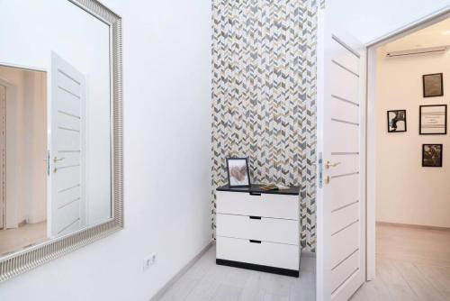 a dressing room with a mirror and a dresser at Central and New design apartment in Budapest