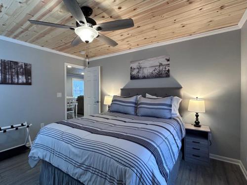 a bedroom with a bed and a ceiling fan at Railroad Street Retreat ~ Close to Trails 8 & 13 in Bergland