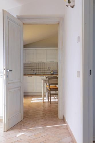 an open door into a kitchen with a table at Relais Parco Del Subasio in Piano Delle Pieve