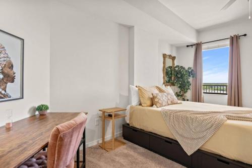 a bedroom with a bed and a wooden table at Stylish Urban Retreat Steps from Lake Eola in Orlando