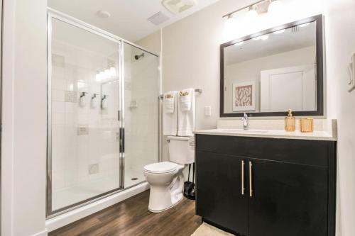 a bathroom with a shower and a toilet and a sink at Trendy Gateway by Lake Eola Free Parking in Orlando