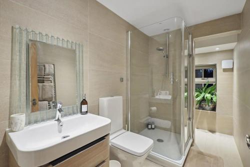 a bathroom with a sink and a shower and a toilet at Squirrel Lodge - 2 Bed Country Home in Market Harborough