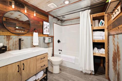 a bathroom with a tub and a toilet and a sink at Redwoods Rising - Sweeping Views-Hot Tub in West Fork
