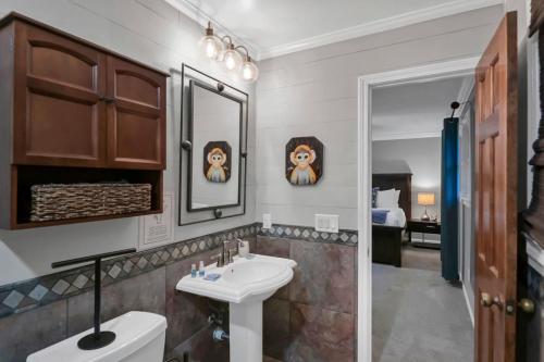 a bathroom with a sink and a mirror at The Quails Nest of Harbison in Columbia