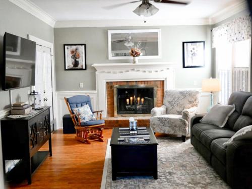 a living room with a couch and a fireplace at Serenity in the Suburbs in Columbia