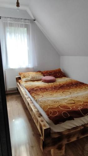 a bedroom with two beds in a room with a window at Woodland house ** in Sântimbru-Băi