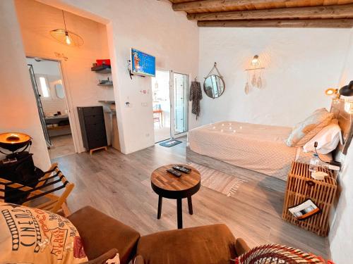um quarto com uma cama e uma mesa num quarto em Alentejo Zen BnB, Cozy suite, Patio, Private pool and entrance, Fire Pit em Alcarias