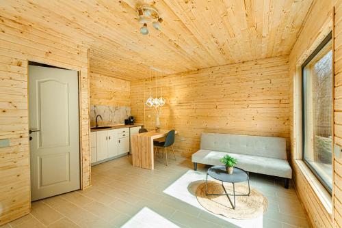 a wooden room with a bench and a table at Apusenity- Refugiu modern în inima naturii, aproape de Cluj in Cluj-Napoca