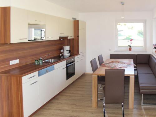 a kitchen with a table and a dining room at Apartment Stefan-2 by Interhome in Hippach