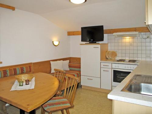 a kitchen with a wooden table and a kitchen with a dining room at Apartment Martina - MHO275 by Interhome in Mayrhofen