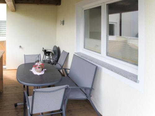 a table and chairs in a room with a window at Apartment Stefan-2 by Interhome in Hippach