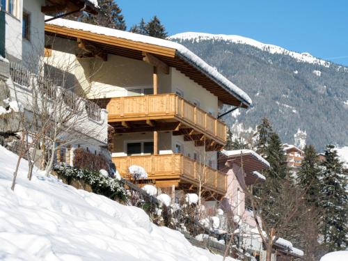 a building on a snow covered slope with a mountain at Apartment Stefan-2 by Interhome in Hippach