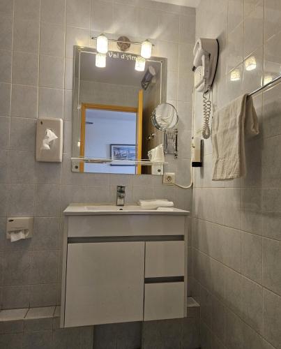 a bathroom with a sink and a mirror at Le Val d'Amby in Hières-sur-Amby