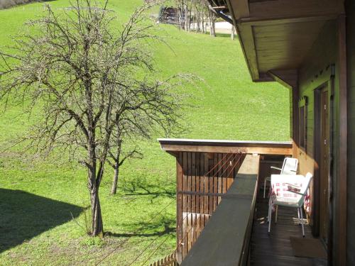 a porch of a house with a table and chairs at Apartment Schusterhäusl - MHO756 by Interhome in Schwendau