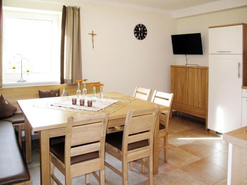 uma cozinha e sala de jantar com mesa e cadeiras em Apartment Talmoosen-Bauer - BMG210 by Interhome em Bramberg am Wildkogel