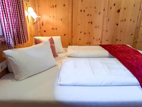 Duas camas num quarto com paredes de madeira em Chalet Wegscheider - MHO326 by Interhome em Mayrhofen